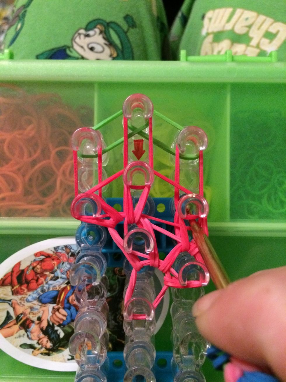 Put your hook in the peg and grab the 2 bands. Move them forward.