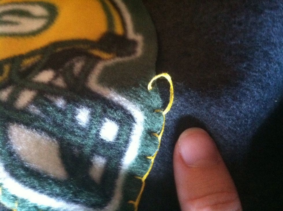 Put your needle through the site of your next stitch. Instead of coming back up at the edge of the appliqu\u00e9, only go down.