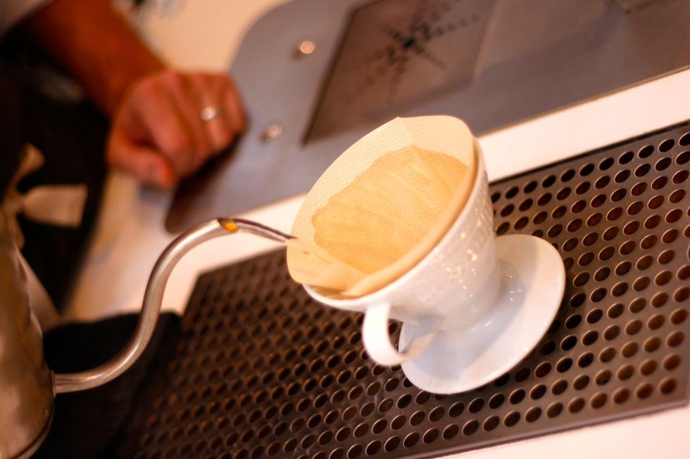Put your paper filter inside the brewer. Wet it with the hot water. This rinses away any paper taste and heats up the brewer, since correct temperature is really important in a good brew.