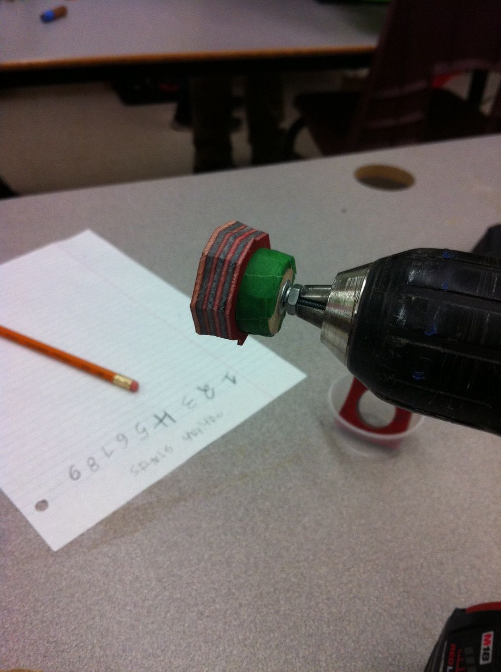 Put your ring on your home made drill bit and put your bit in your drill