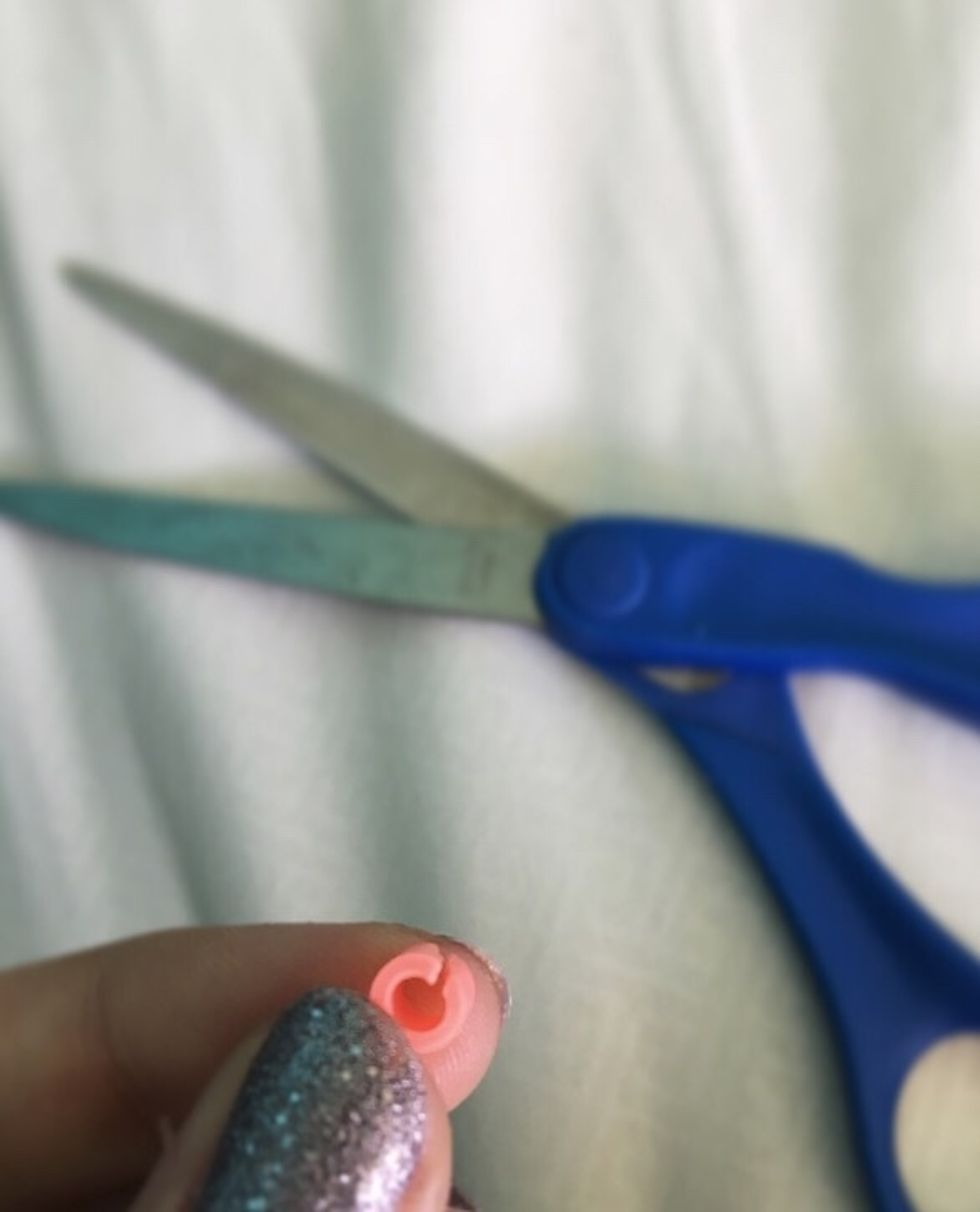 Put your scissors in the middle of the bead, and cut a a slit right through it.
