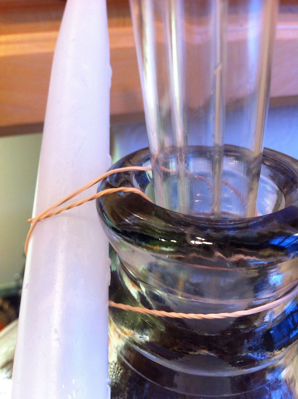 put your siphon setup together and fasten it to your 5 gallon carboy. you want it about 3/4 of the way down. not touching the bottom of the carboy. I use a rubber band because I'm a clown.