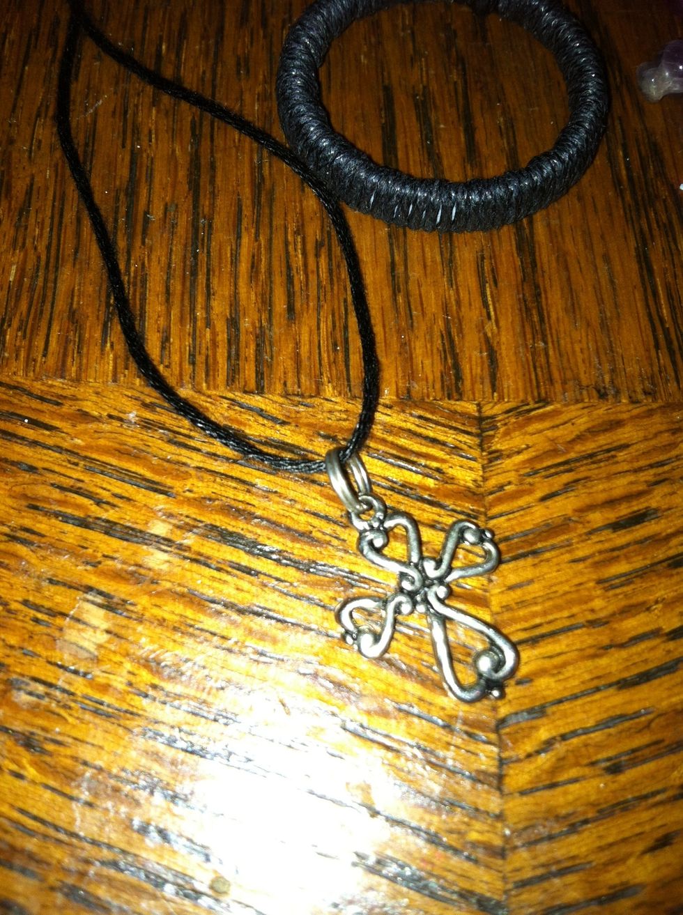 Put your string through your center charm. Make your side even. (sorry its so bright without the flash it's too dark)