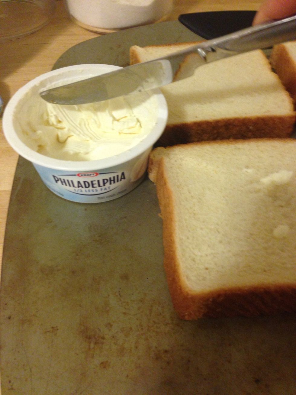 Put your toast slices on the pan and spread a thin later of cream cheese on each slice. It's about 1/2tsp per slice.