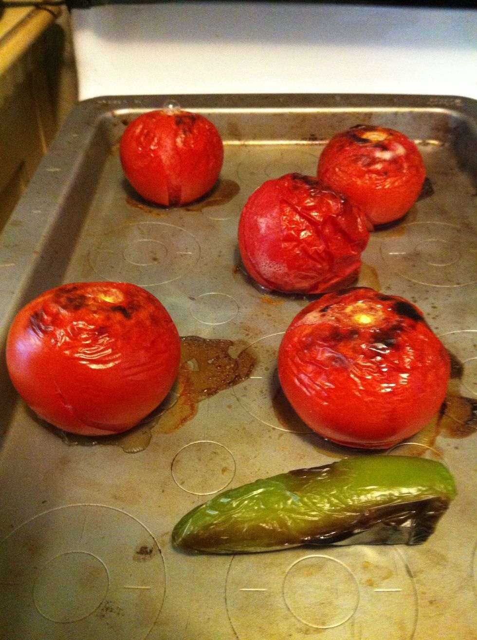Put your tomatoes and jalape\u00f1o on a edged cookie sheet and broil them for 6 minutes. Flip them all with tongs and broil them again for 6 minutes. Make sure you put the sheet on a top oven rack.
