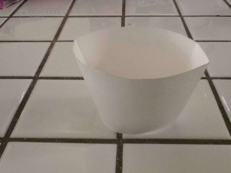 Put your wrapper together with tab and make sure it is balanced correctly... you will put baked cupcakes in after they are cooled. I like to frost after putting into wrappers though...