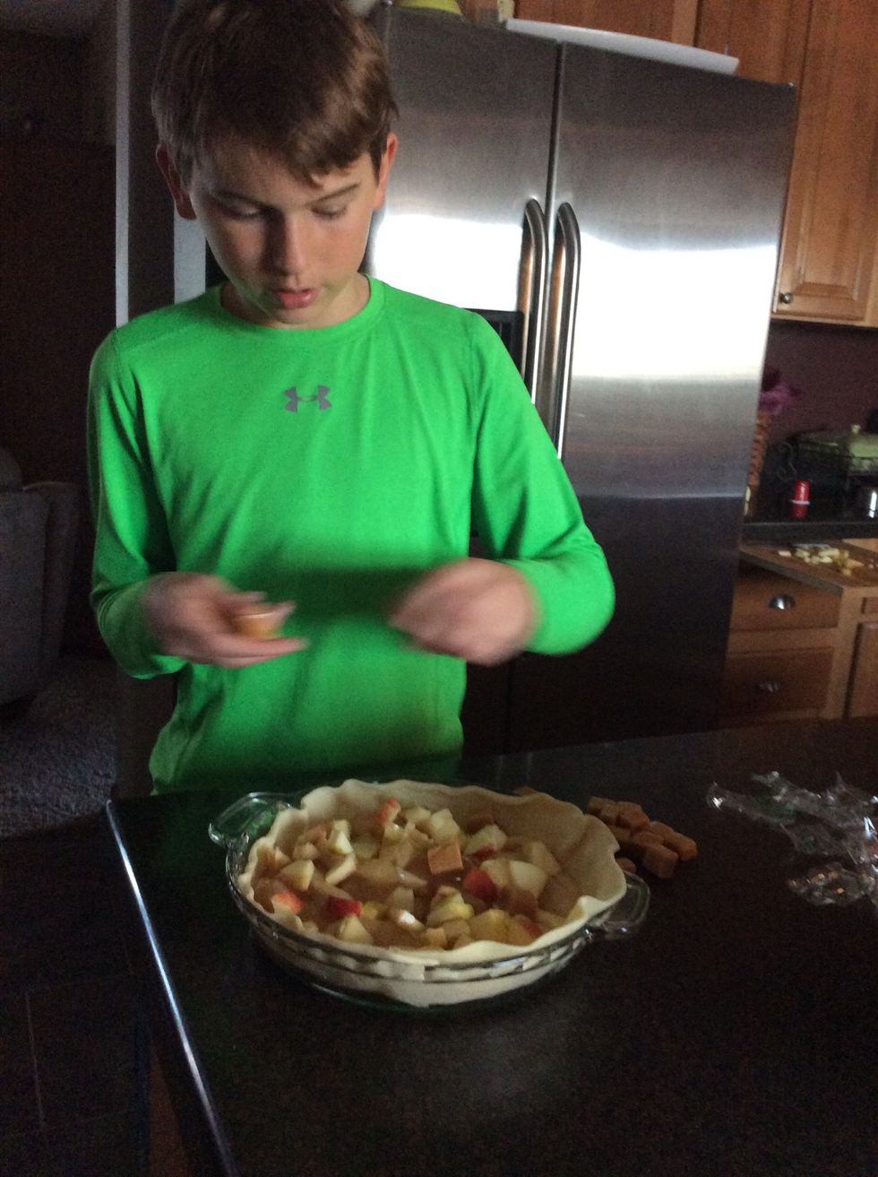 Putting caramels in the pie.