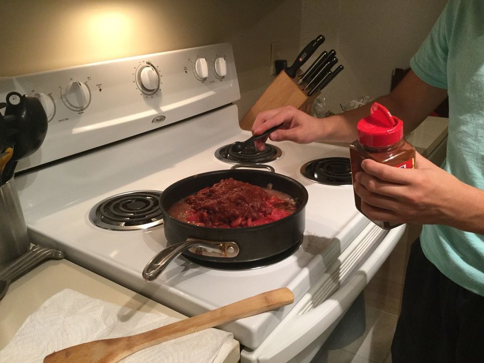 Putting the chili powder into the chili