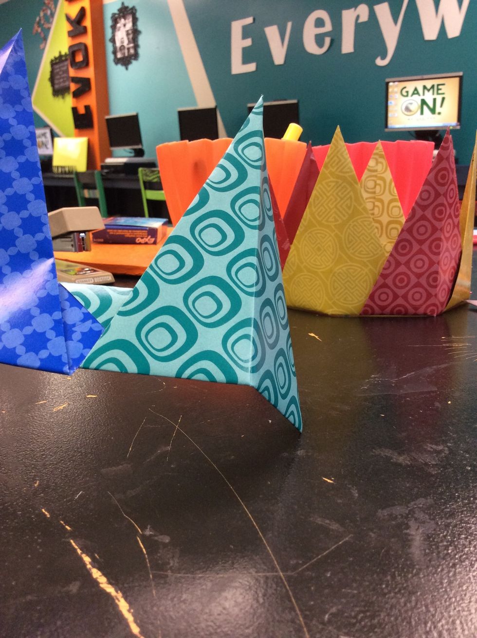 Putting the pieces is difficult to explain but I will try my best. First slip one of the pieces into the slit in another piece. Try to slide into place.