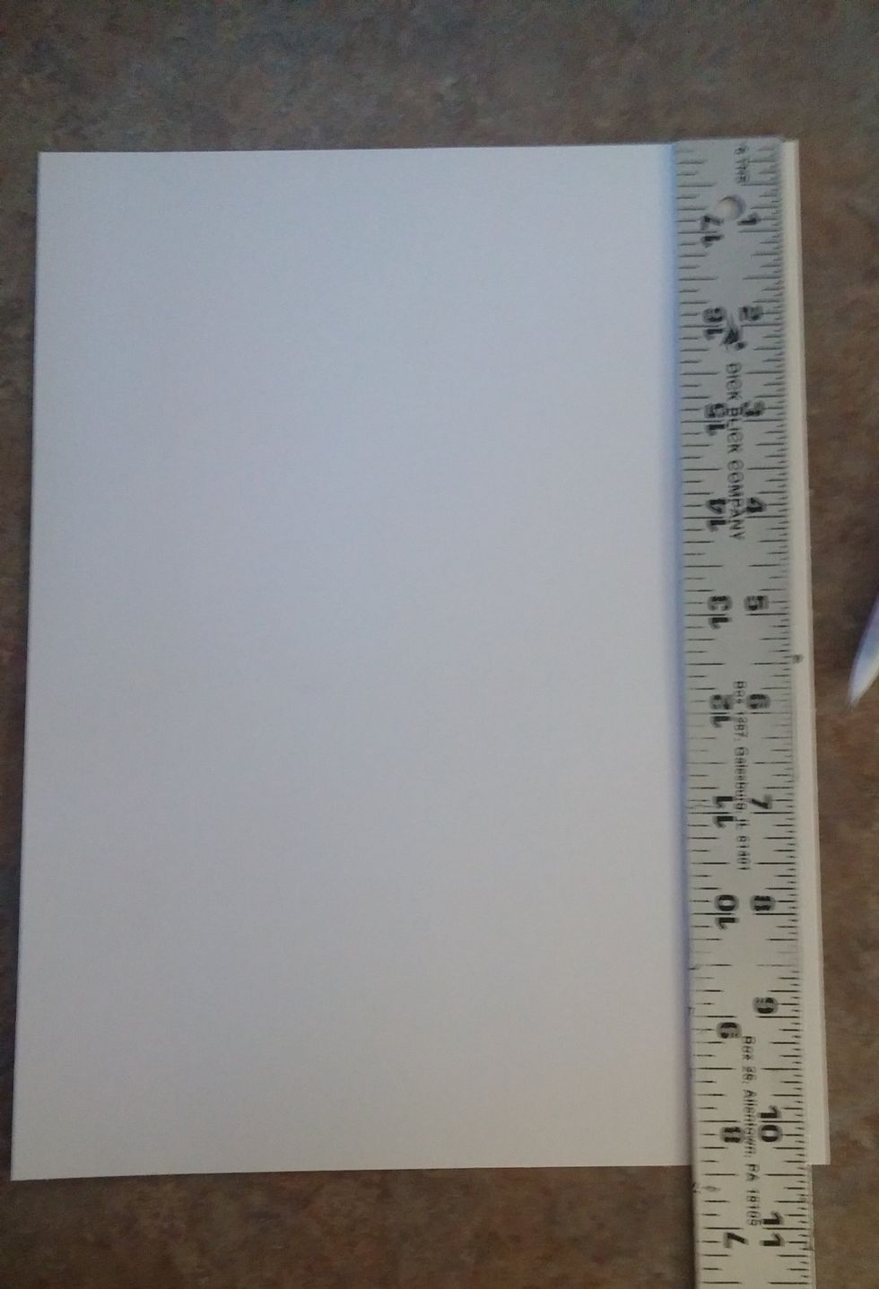 Putting the ruler along the side, make a mark at 5 1/2 inches on both the left an right side of the paper