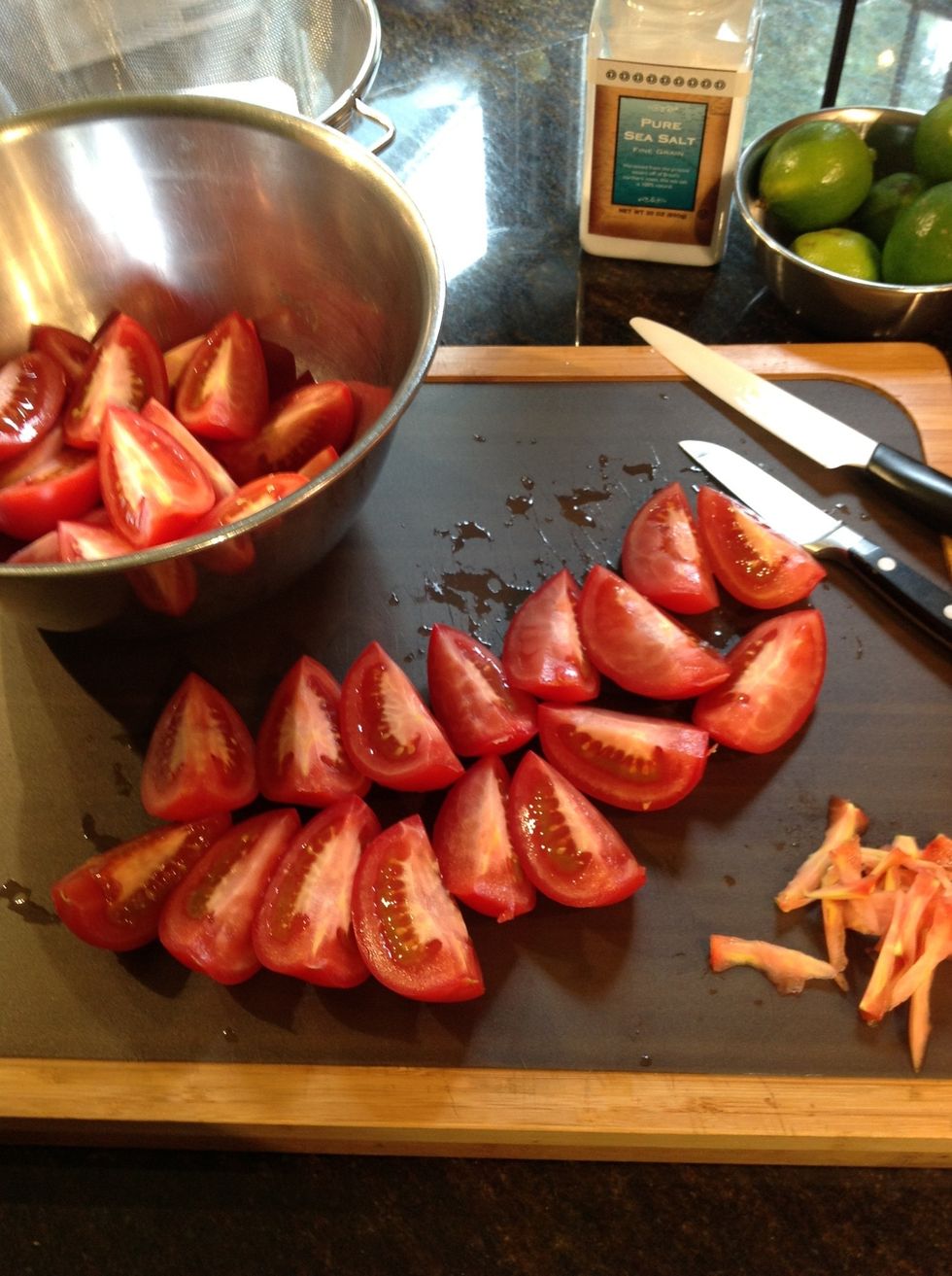 Quarter and core tomatoes preparing to remove seeds.