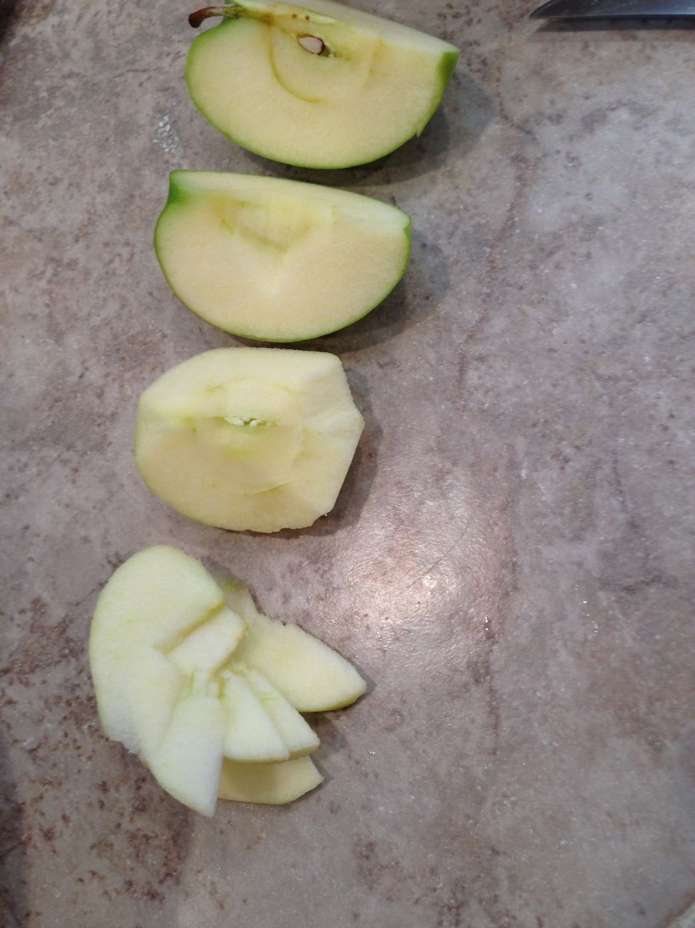 Quarter, core, peel, and chop apples into slices.