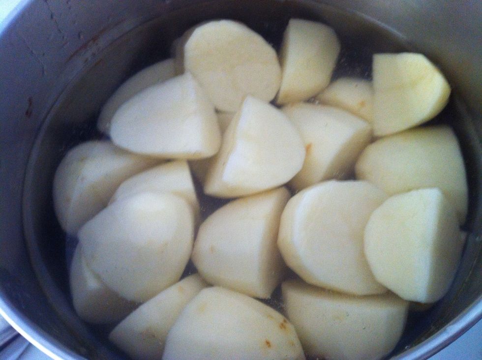 Quarter the potatoes and place in  a pot of water. Boil the potatoes.Drain and keep aside