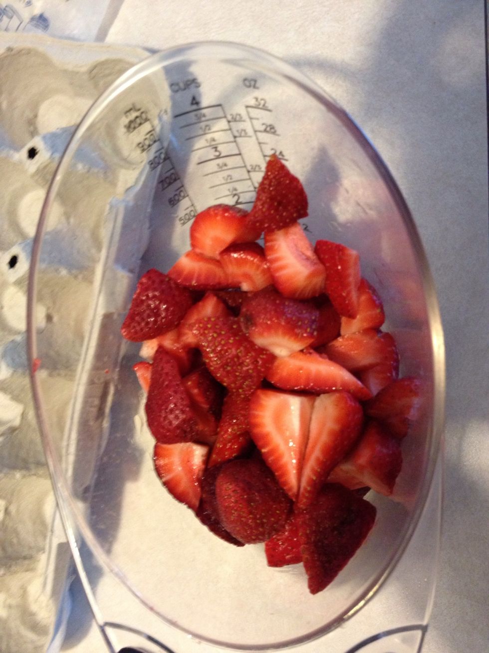 Quarter the strawberries