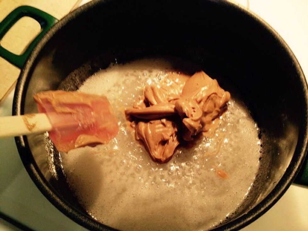 Quickly add peanut butter to the sugar and corn syrup mixure