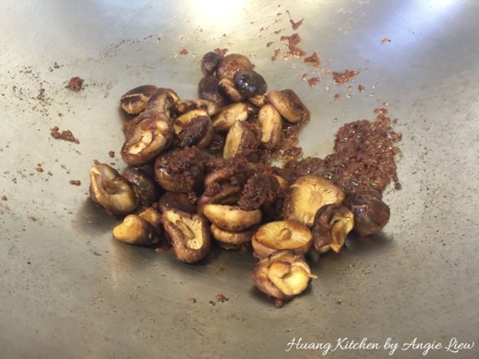 Quickly add the sesame infused fried shiitake mushrooms. Fry to make sure the mushrooms are coated with the bean paste.