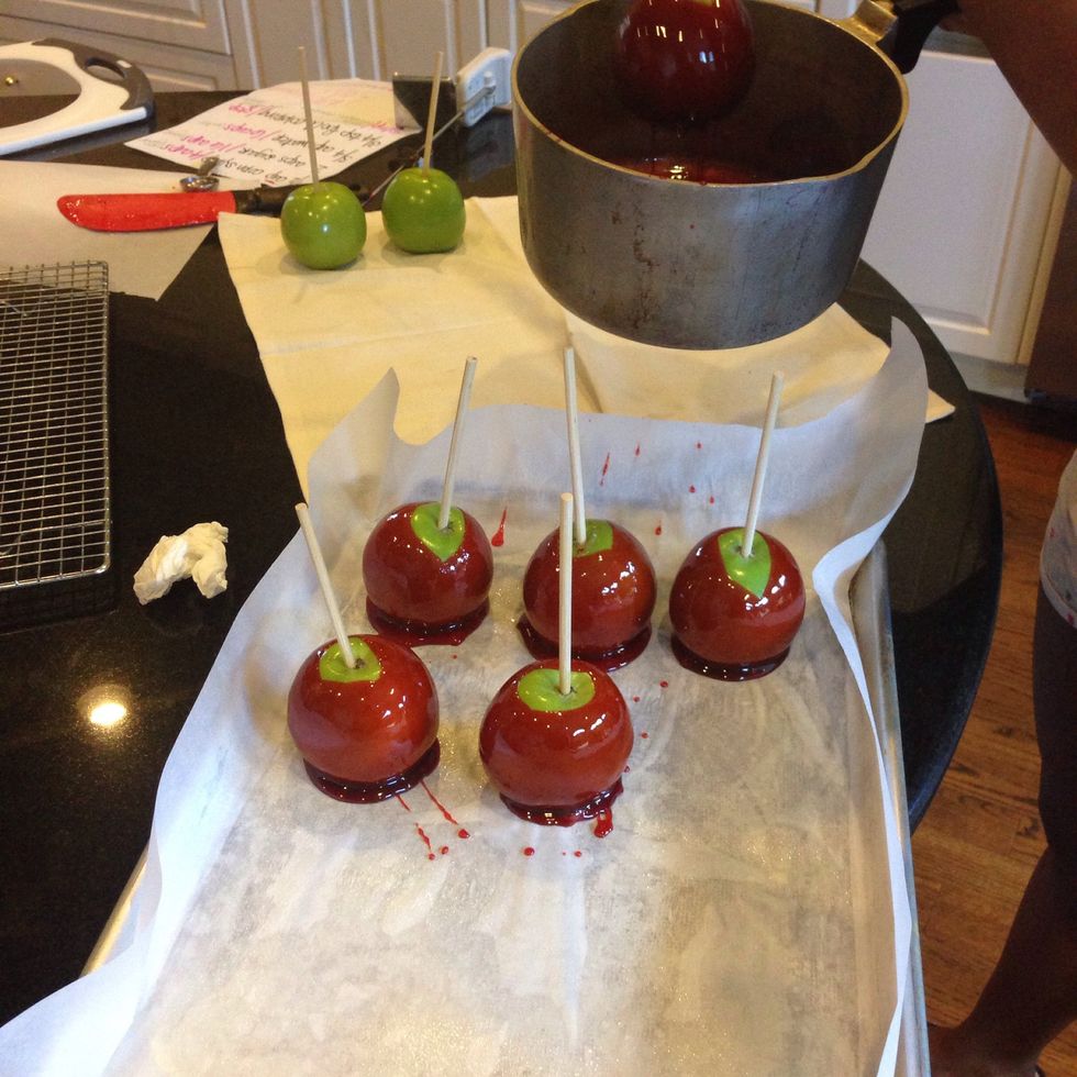 Quickly dip apples twice and place on cooking sheet. If candy begins to harden just place back on heat until back to softball stage temperature 290-310 degrees Fahrenheit.