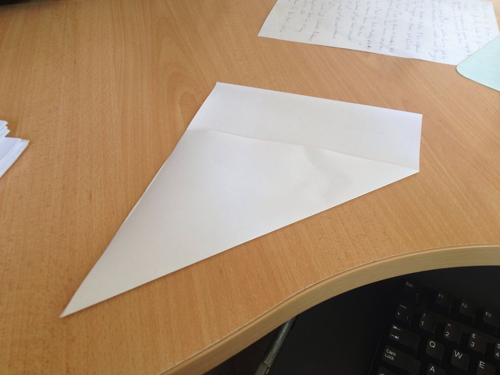 Quickly Fold one side of the sheet to make a triangular shape with one end still rectangular, as shown on the photo.