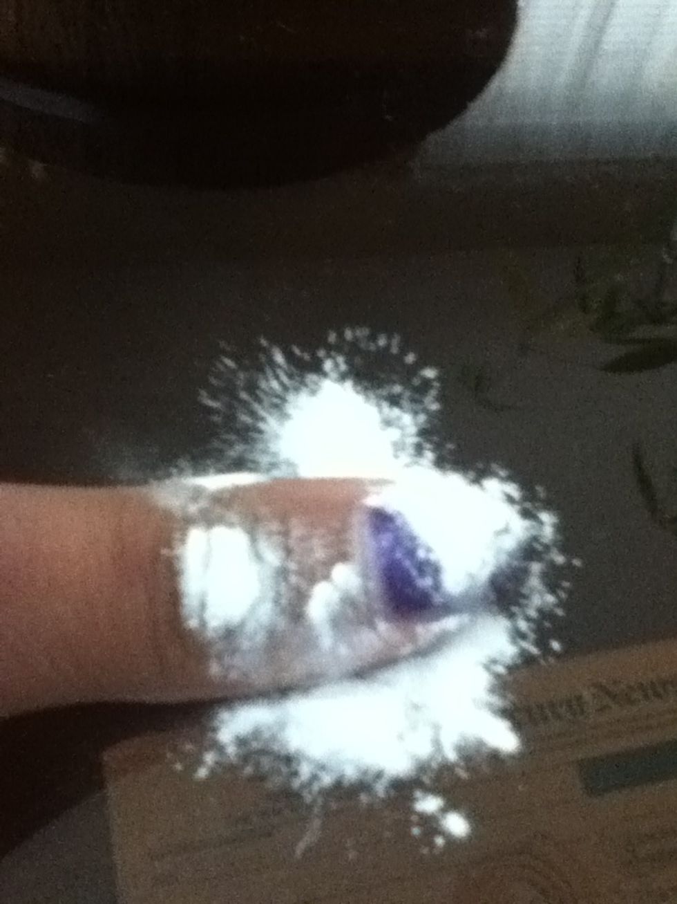 Quickly while still wet, Sprinkle baby powder or cornstarch over the wet polish