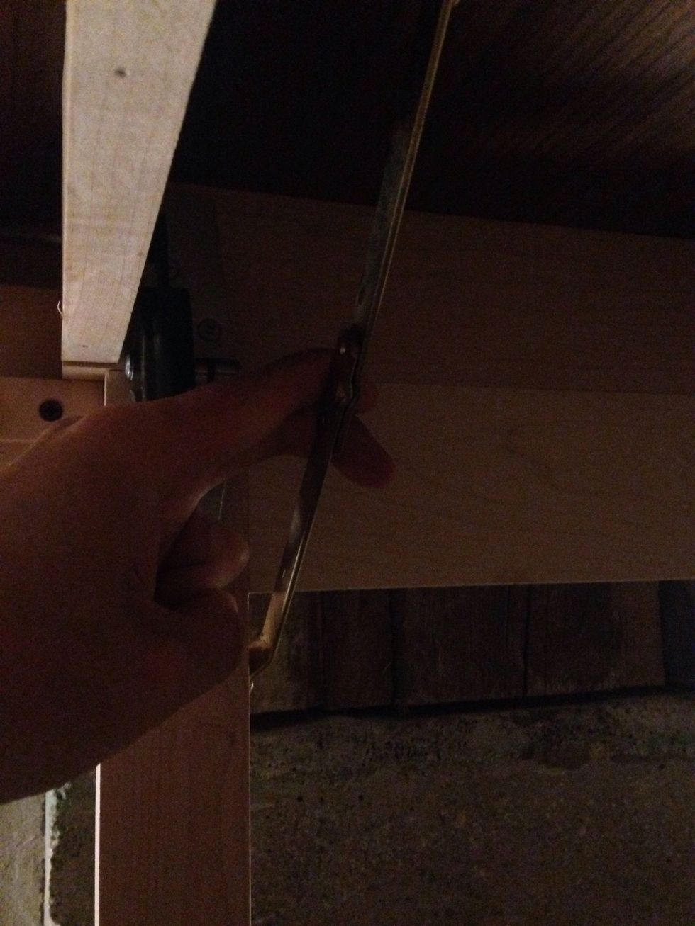 Raise the table to a height that you can access underneath. Pull the metal supports so the legs will collapse