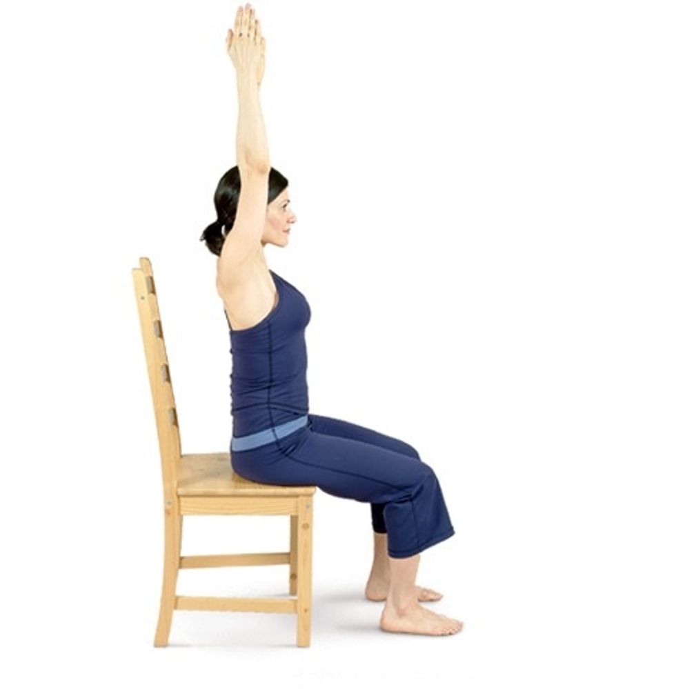 Raise your arms above your head, palms facing, your shoulders relaxed & down.