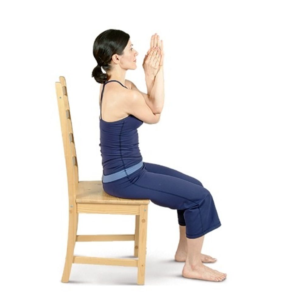 Raise your arms to shoulder height in front of you, palms facing up. Cross your left arm over your right arm so your elbows are on top of each other.