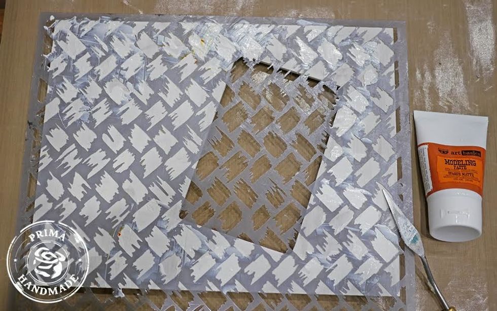 Randomly apply texture and design to photo frame using stencil and modeling paste.