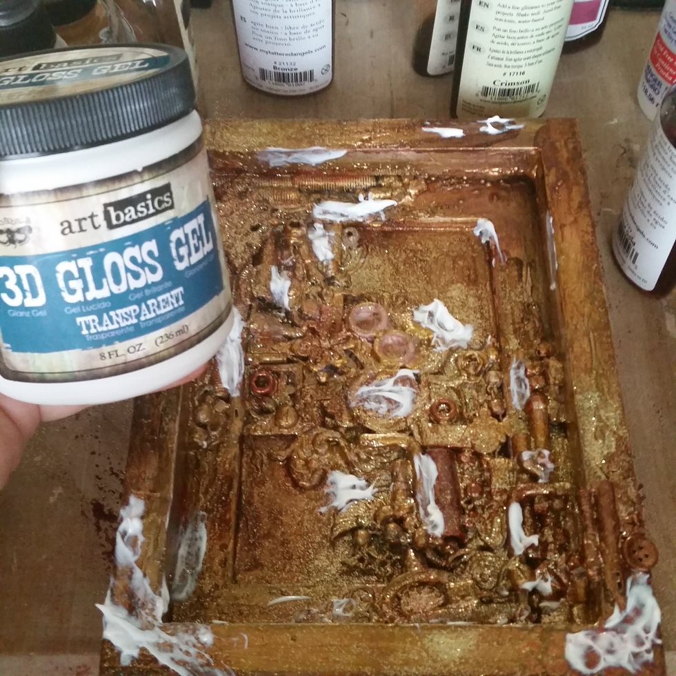 Randomly place gloss gel (like a clear drying glue) around the piece and add small beads, mica, glitter, etc for more texture. Let it dry.