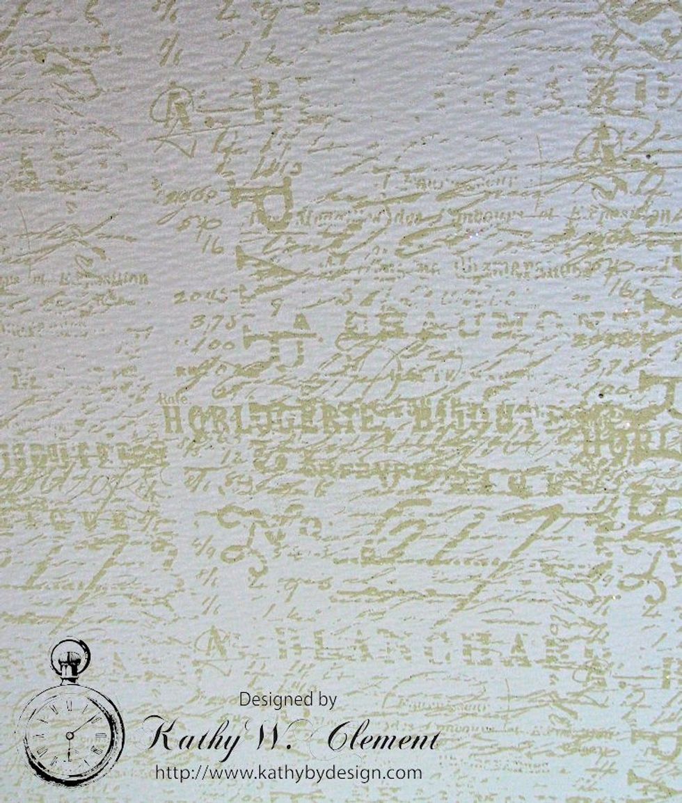 Randomly stamp the French text stamp over the entire surface of an 8.5" x 11" sheet of Ranger Watercolor paper. Sprinkle with Superfine White Embossing Powder and set with your heat gun.