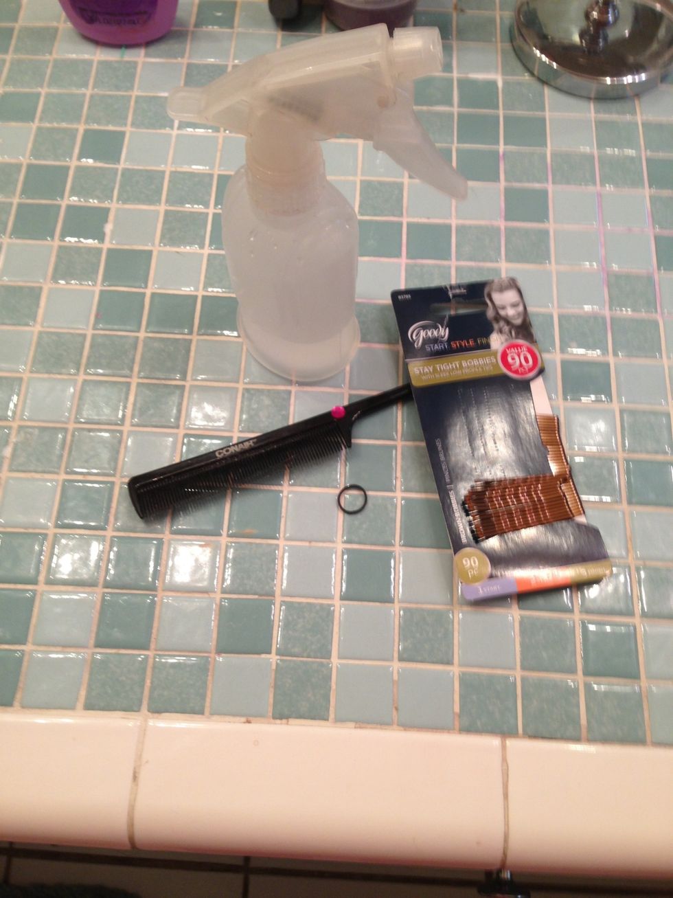 Rat tail comb bobby pins rubber band and hairspray bottle with water