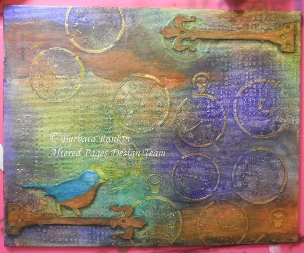 Re-align Time Travel Stencil over stenciled images and use a sponge dauber to apply Delicata Golden Glitz through stencil. This will highlight the images.