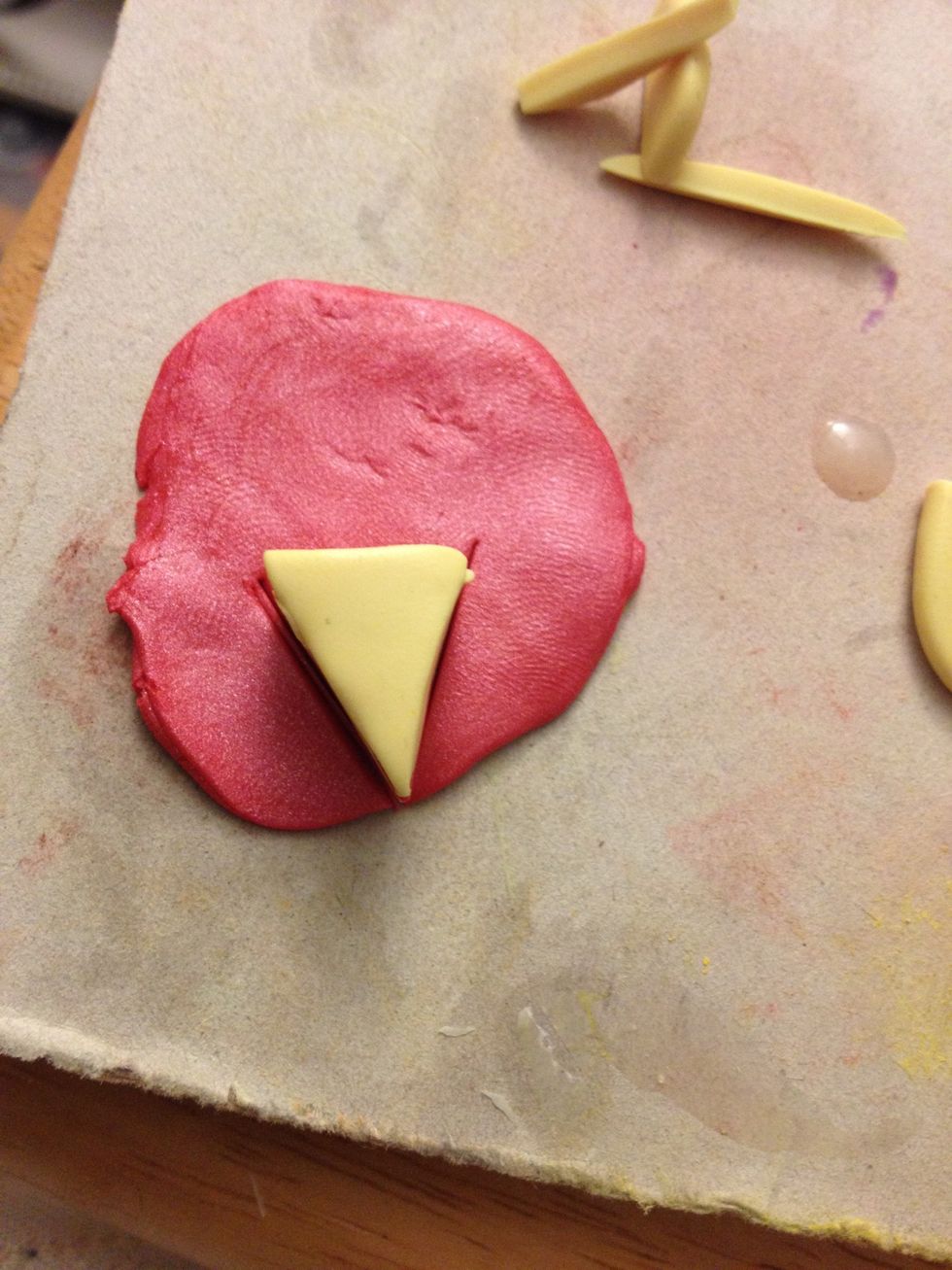 Re-flatten the icing color and place the cake on top. Begin to make another triangle, but don't finish the third side at the top.