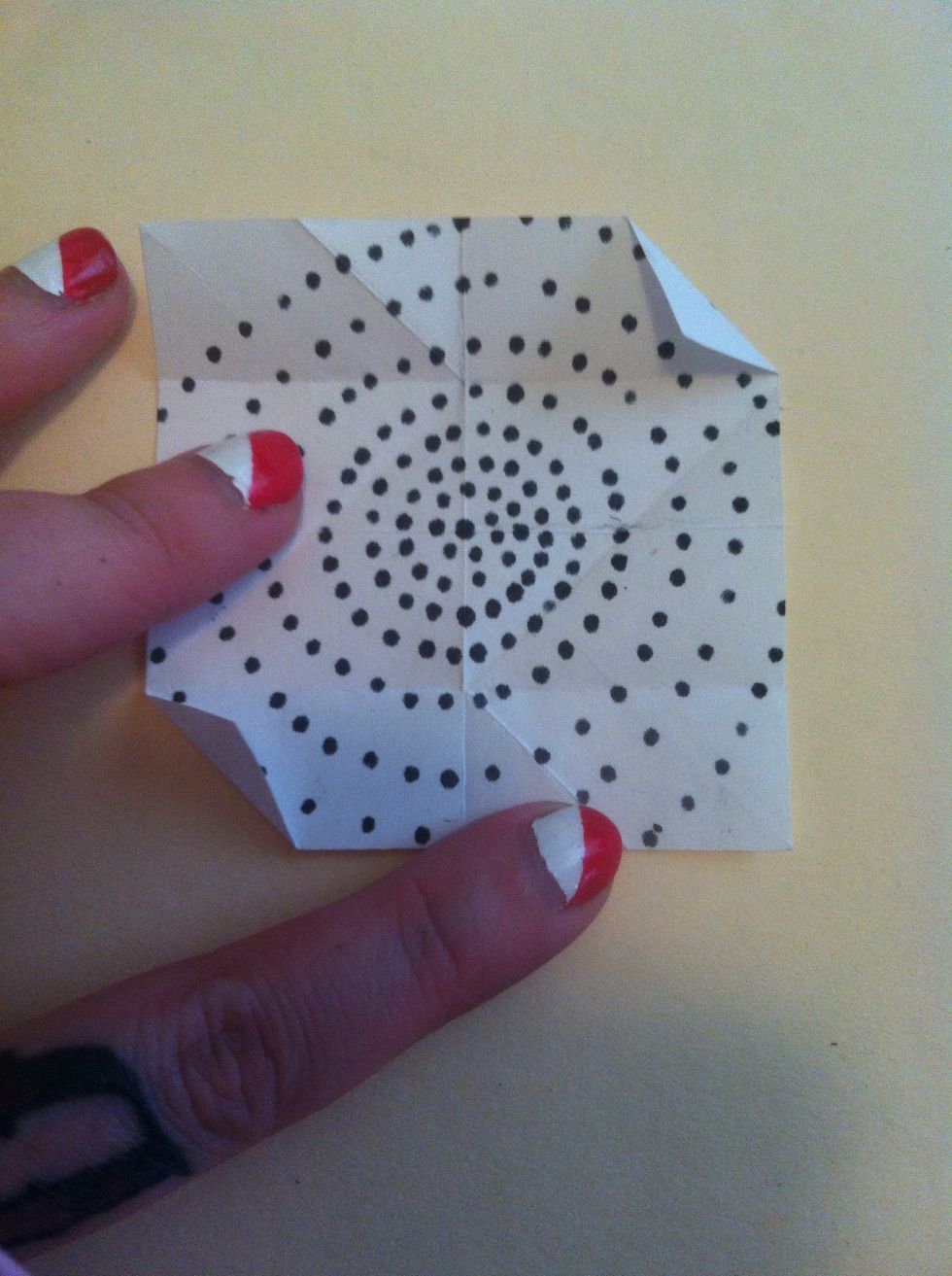 Re-fold the two corners as shown.