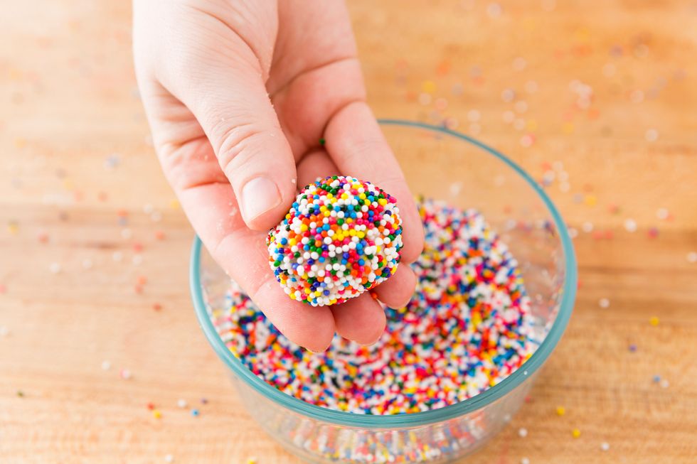 Re-roll in sprinkles and place on a parchment paper lined cookie sheet. Press down slight to form a disk and then bake as directed.
