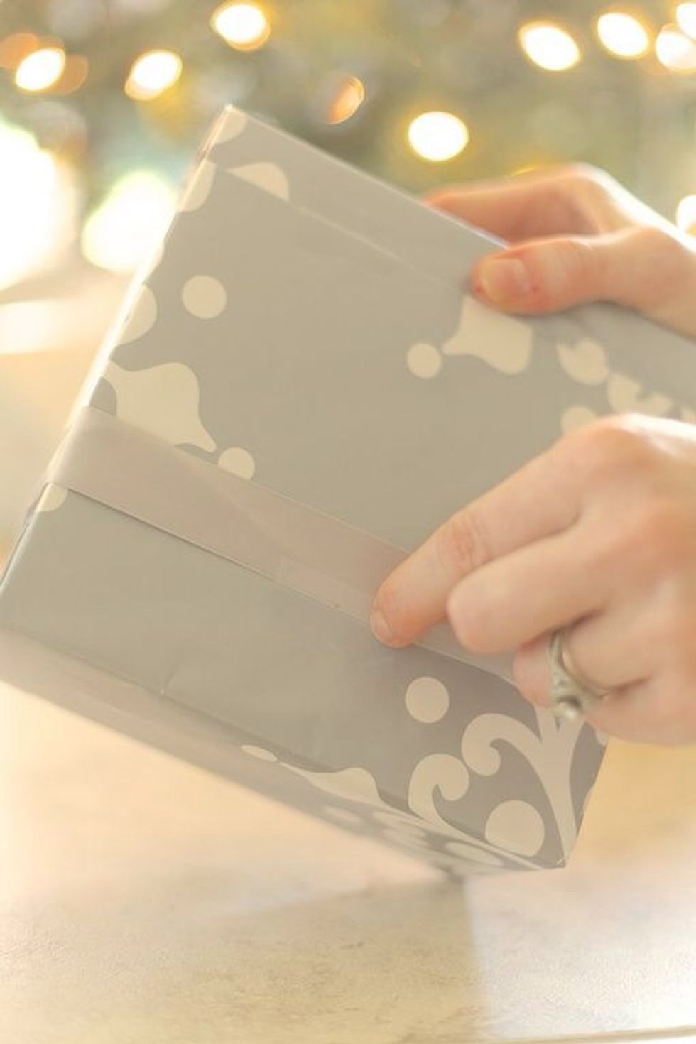 Re-tighten your bow as needed and even out anything else. Slide the bow where you want it and tape the ribbon on the underside. This is good to do if you have kids, pets, or will be traveling.