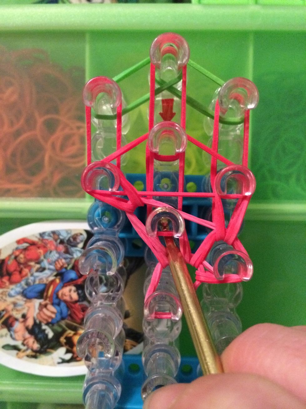 Reach back in the same peg and grab the next 2 bands. Move the forward.