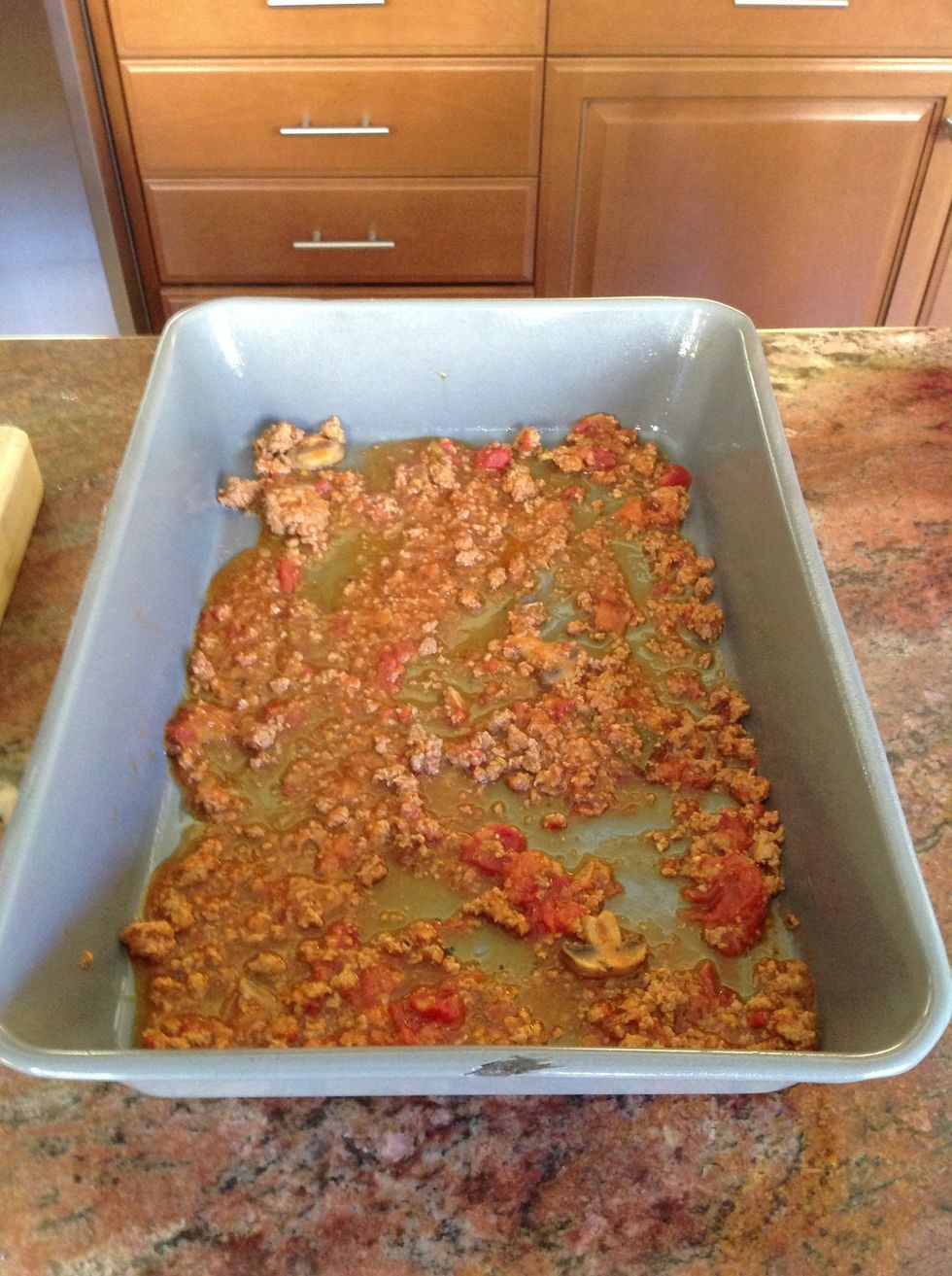 Ready to build? Pasta sauce I made a couple nights before and lightly cover the bottom. We go lighter on the first level, so we have more for the other levels. I'm sure you will notice.