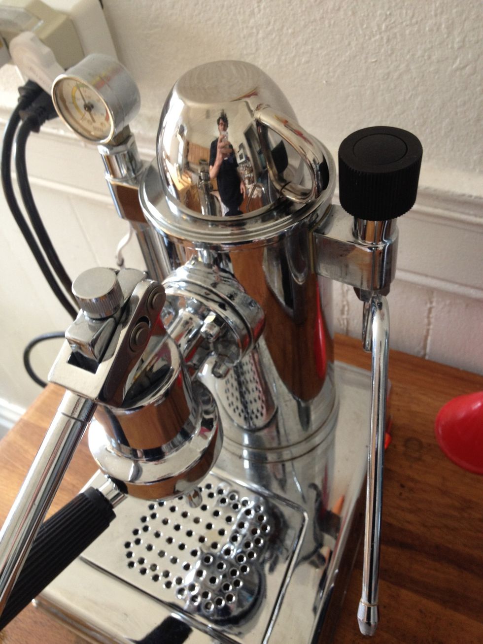 Ready your espresso cup! Just like the portafilter, a warm cup will serve you best. I preheat mine by resting them on the machine during prep \u2014 like this.