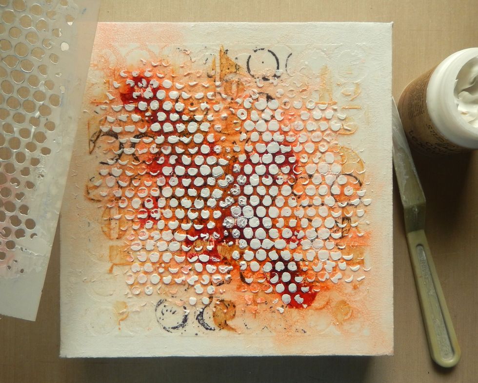 Reapply more Crackled Texture Paste through the Bubble Layering Stencil to replicate the original layer. Allow to dry. Then apply a thin layer of Matte Distress Collage Medium to seal the surface.