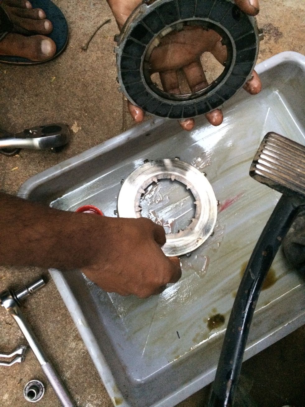 Reassemble them in the order of removal or refer to the diagram in step 23. Alternate friction plates and metal plates.