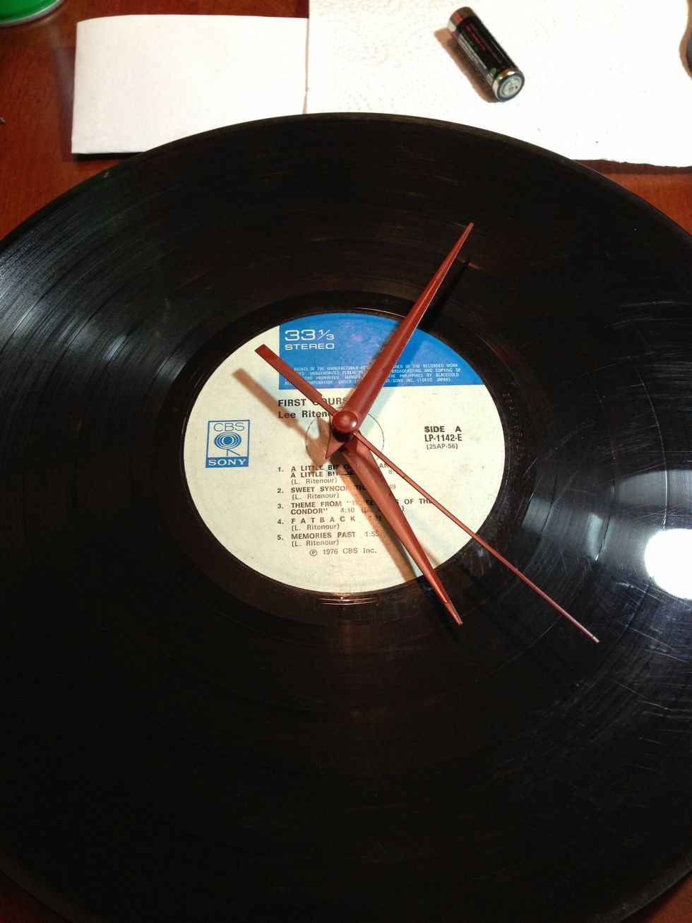 Reattach the hands by reversing the order in which you removed the hands (hour, minute then second hands). At this point, you can already place the finished vinyl clock on top of a bookshelf or table.