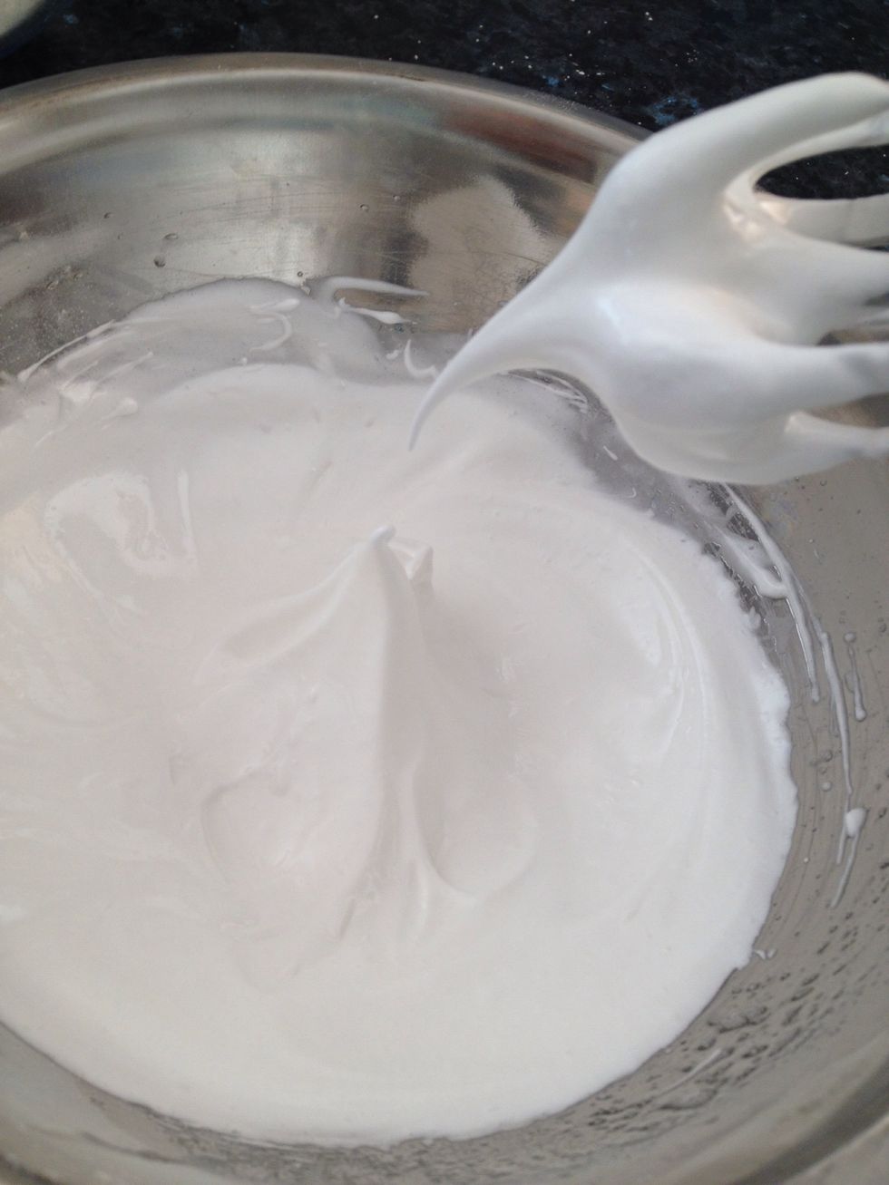 Reduce the speed while adding the caster sugar in increments. When all is added, increase the speed until stiff peaks form.