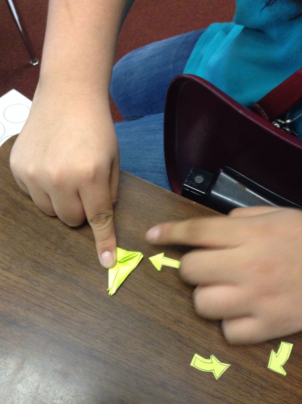 Refold the flaps and fold down the big triangle at the top and unfold all the flaps again. And then unfold the top triangle.