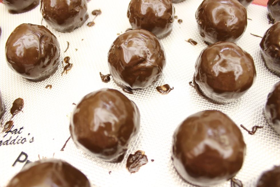 Refrigerate the cake balls until the chocolate coating hardens. Once the chocolate coating has hardened, proceed to the next step.