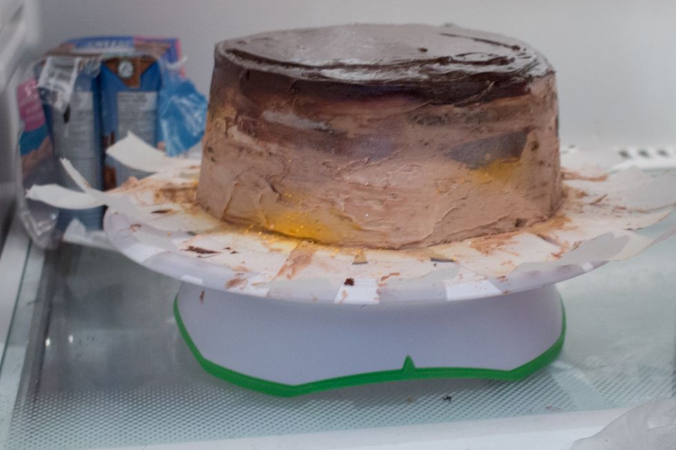 Refrigerate your cake for 5-10 minutes just so the ganache has a chance to harden.