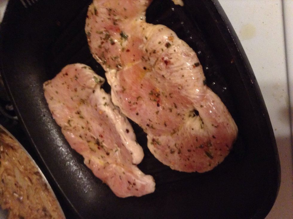 Reheat grill pan and place in chicken breasts -- let brown on one side
