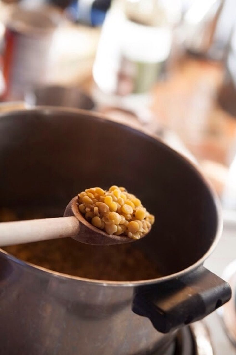 Reheat the sugar syrup until it starts to thicken. This should take about 2 minutes Add the cooked chana dal to the sugar syrup.