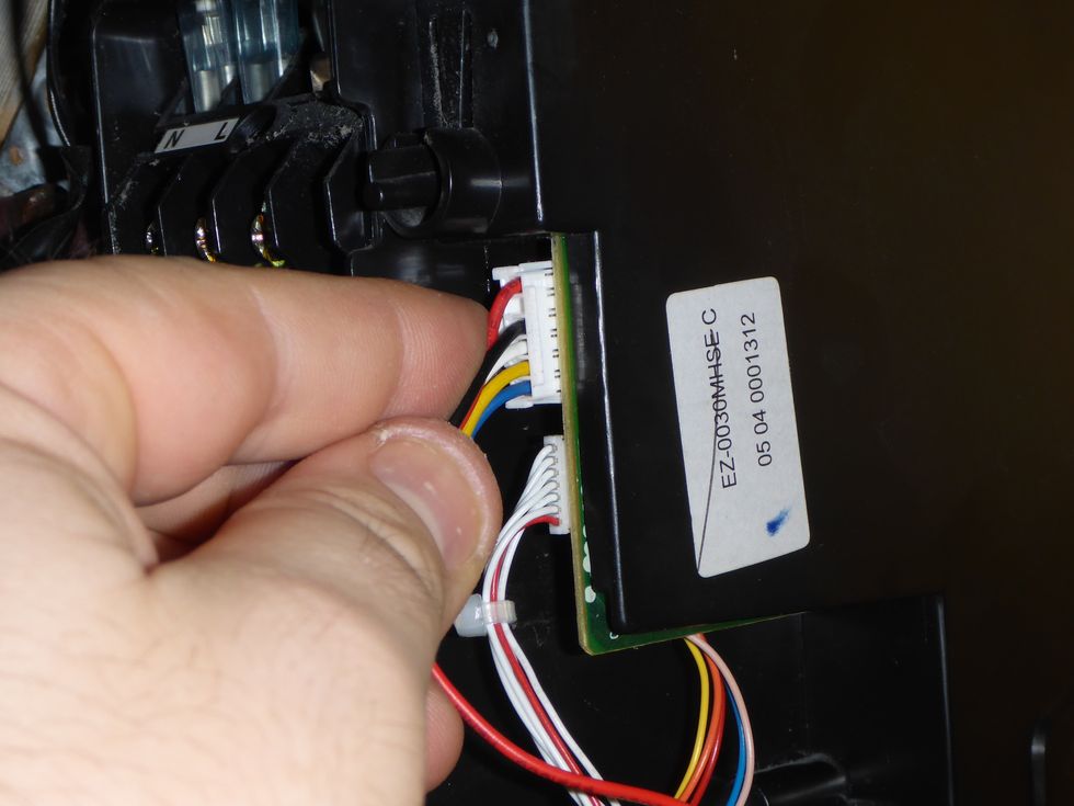 Release and remove the fan motor connector.