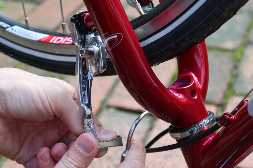 Release the brake on the tire that needs to be changed.