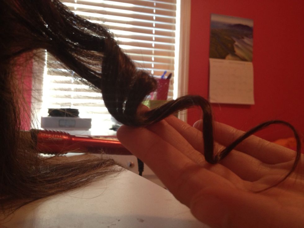 Release your grip on the hair and catch the curl as it rolls off the curling iron.